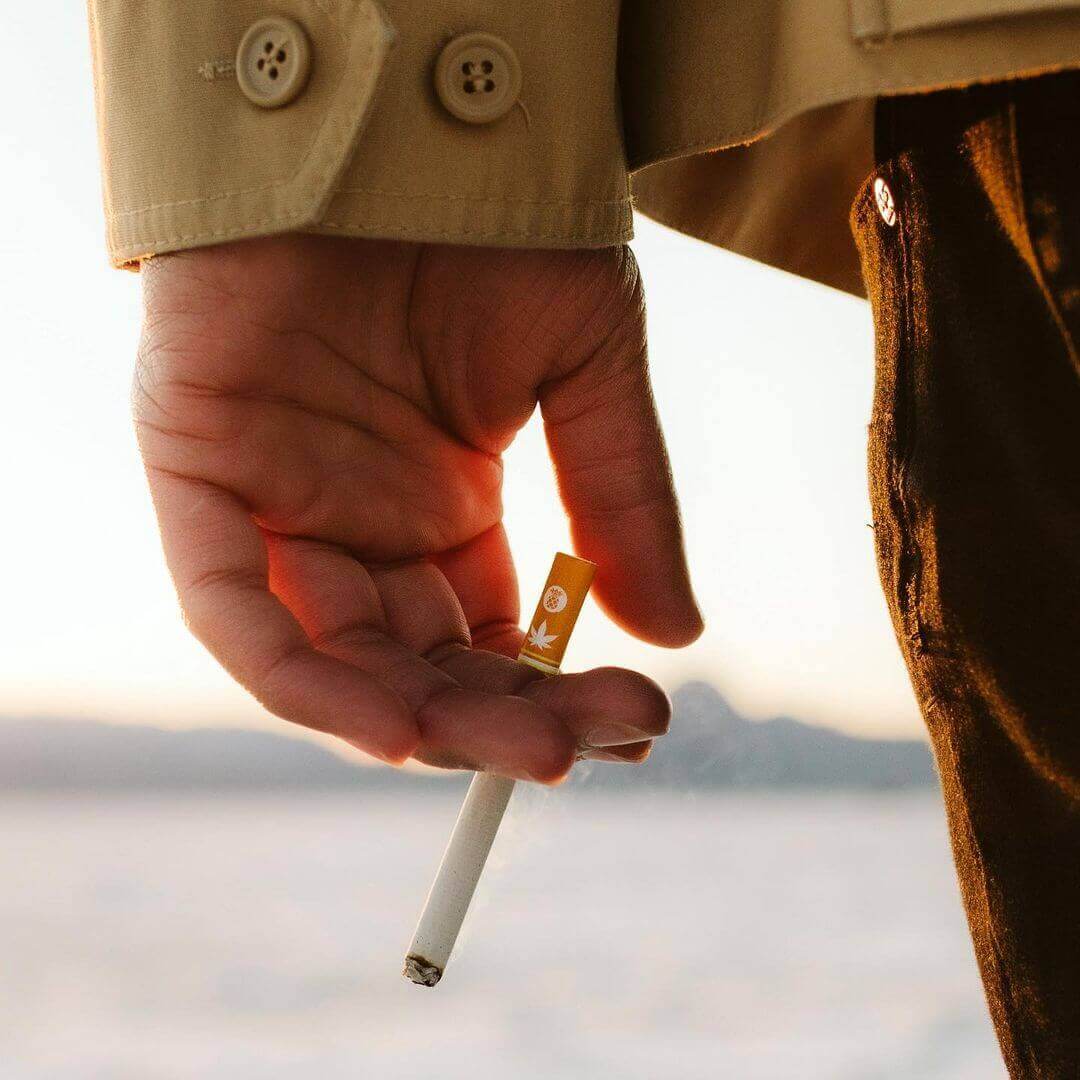 holding a cigarette mountain smokes hemp cbd smokes | Mountain Smokes